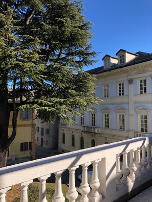 A building with classical architecture, a balcony with balustrades, and a large tree in the foreground. - Palazzo7 (DOMODOSSOLA)