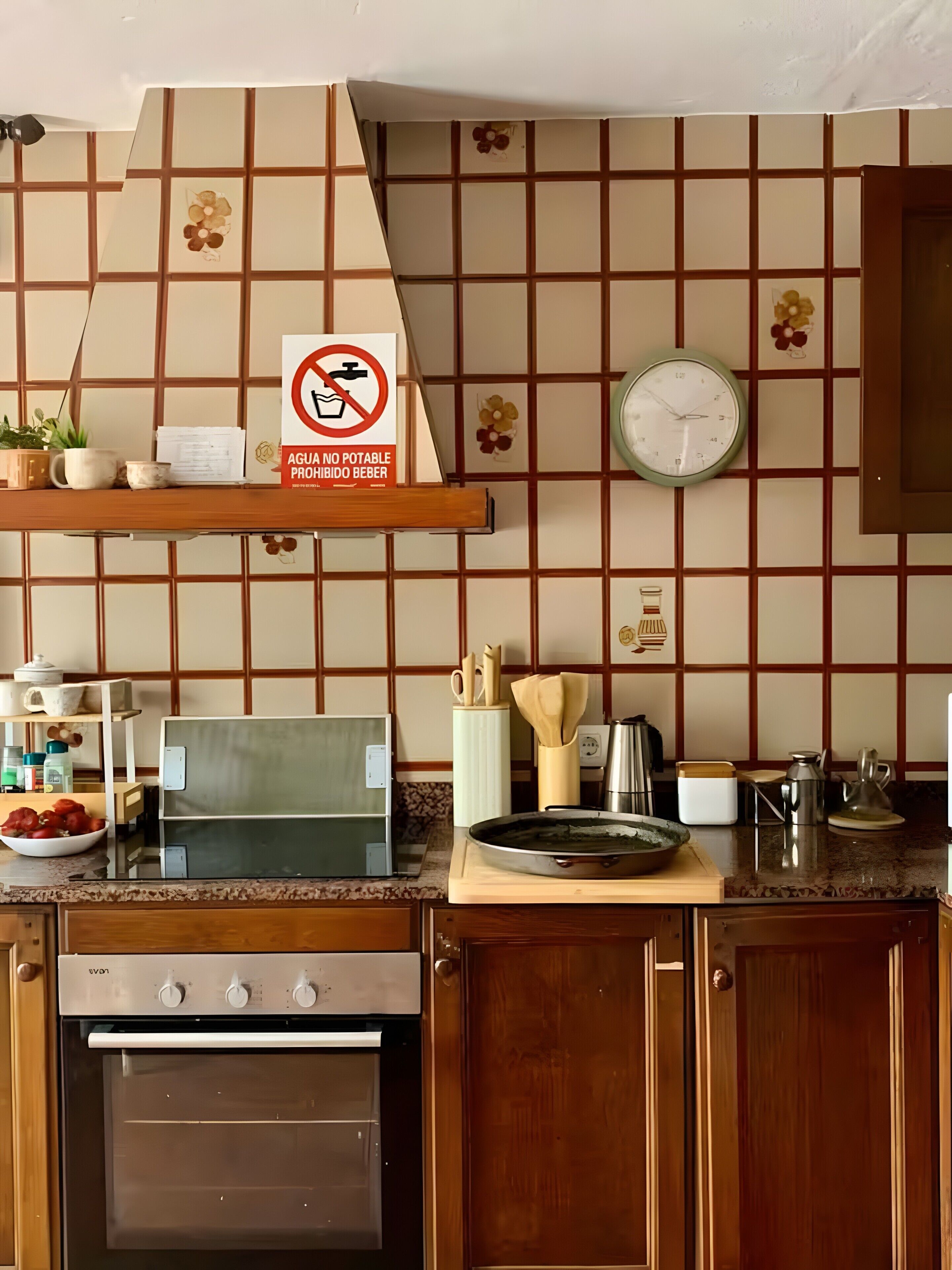 A kitchen with a stove, oven, and various kitchen items on the counter.