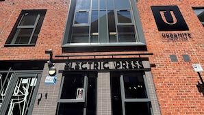A multi-story building with a brick facade, large windows, and a sign for 'Urbanite Student Living.' - Electric Press  (Sheffield)