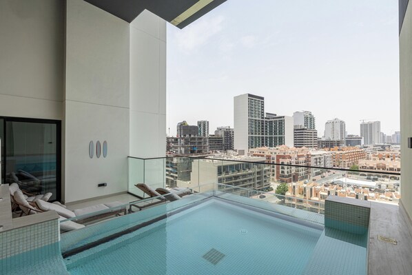 2 outdoor pools, open 8:00 AM to 10:00 PM, pool umbrellas, pool loungers - Gala Guests - Binghatti Onyx Suites (Jumeirah Village Circle)