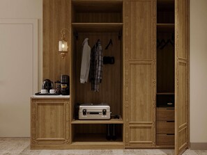 A wooden wardrobe with a built-in shelf, a hanging rack, and a small table with a coffee maker and cups. - Mercure Khiva Hotel (Khiva)