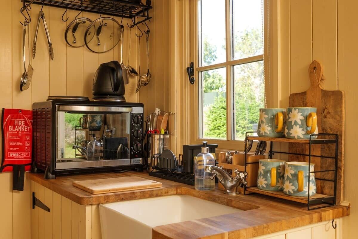 Eine Küche mit Herd, Spüle und Fenster.