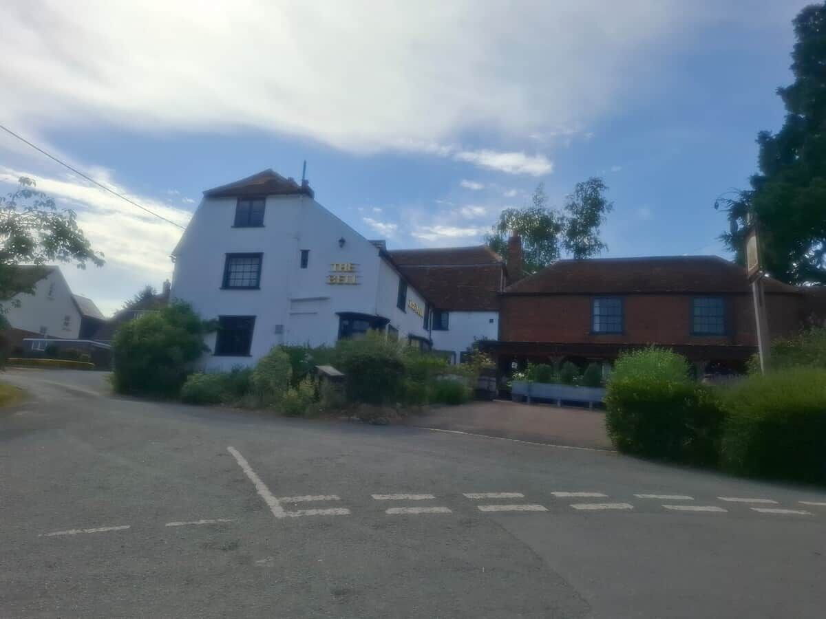 A white building with a sign that reads 'The Old Mill.'