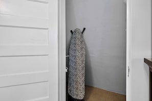 A white door with a towel rack holding a patterned towel.