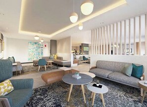 Una sala moderna con un sofá, sillones, una mesa de centro y un televisor.