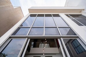 A modern building with large windows and a balcony with hanging lights. - Stunning Penthouse in the City Centre (Ho Chi Minh City)