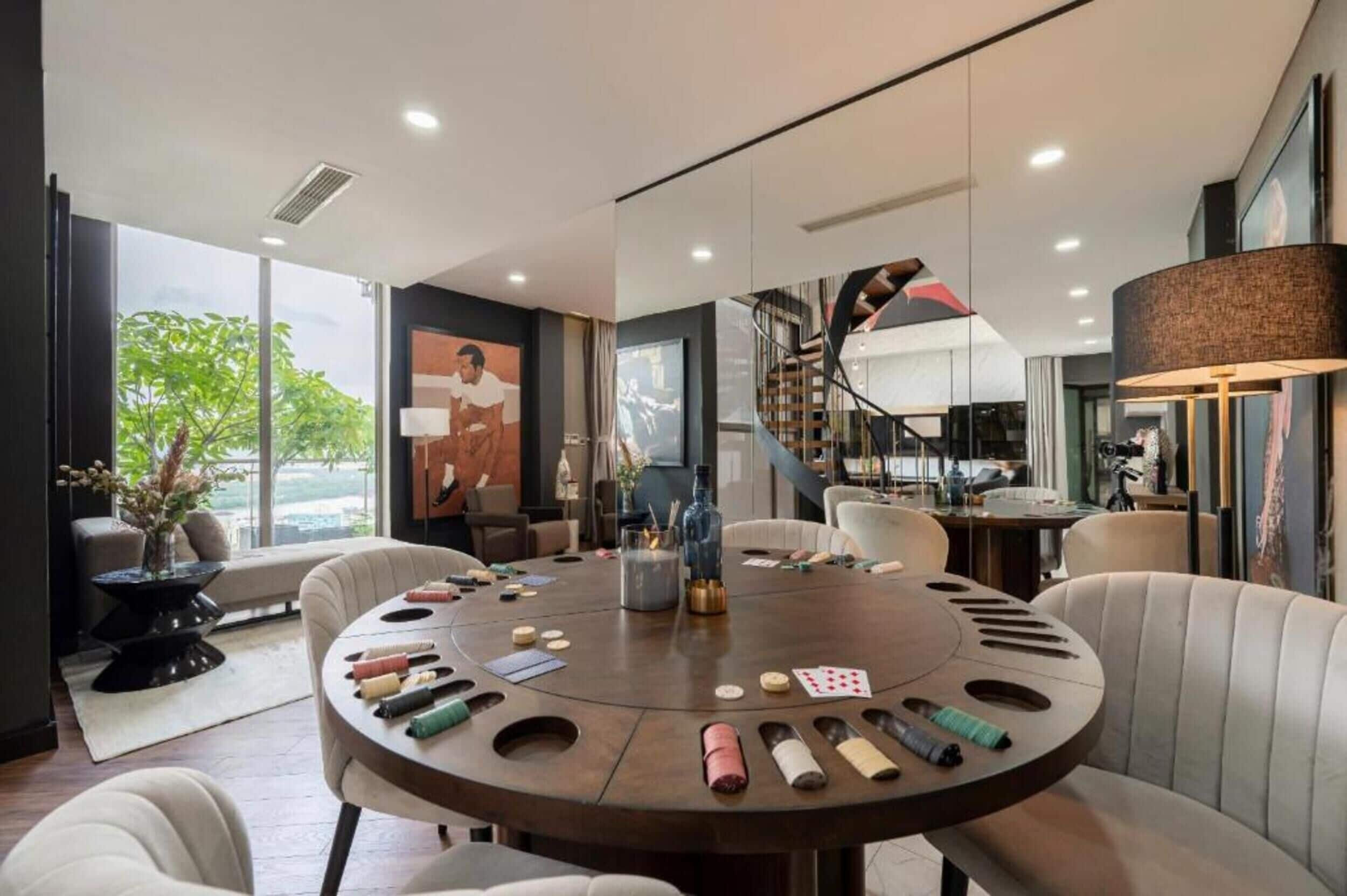 A modern dining area with a round table, chairs, and a view of the outdoors.