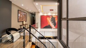 A modern interior with a staircase, a large abstract painting, and a minimalist design. - Stunning Penthouse in the City Centre (Ho Chi Minh City)