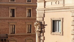 A building facade with multiple windows and a classical architectural style. - ARCASuite Trevi (Rome)