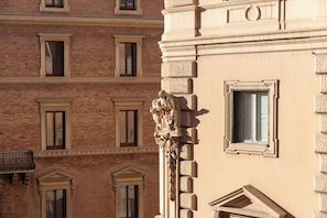 A building facade with multiple windows and a classical architectural style. - ARCASuite Trevi (Rome)