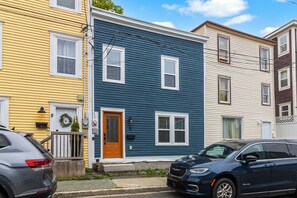 A row of multi-story residential buildings with a front porch, a mailbox, and a door with a wreath. - Bond St Boutique 3BR Deck BBQ Downtown (St. John's)