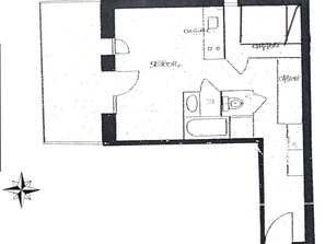 Ein Grundriss mit einer Küche, einem Essbereich und einem Schlafzimmer.