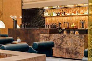 A modern bar area with a marble counter, a variety of liquor bottles, and a fruit bowl. - Delphi Suite | Pool, Pets Allowed | Near Hollywood Walk Of Fame - 6.6 miles (Los Angeles)