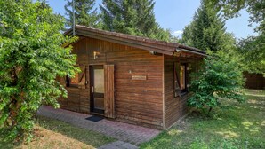 A wooden cabin with a door, a window, and a small porch area. - Amazing home in Merzalben (Merzalben)