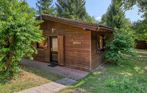 A wooden cabin with a door, a window, and a small porch area. - Amazing home in Merzalben (Merzalben)