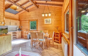 A wooden cabin interior with a kitchen, dining area, and a large window. - Awesome home in Merzalben with WiFi (Merzalben)