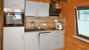 Coffee/tea maker, fridge, stovetop, cookware/dishes/utensils