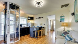 A modern kitchen with a central island, bar stools, and a ceiling fan. - Walk to Beach at the End of the Street! (St. Augustine)