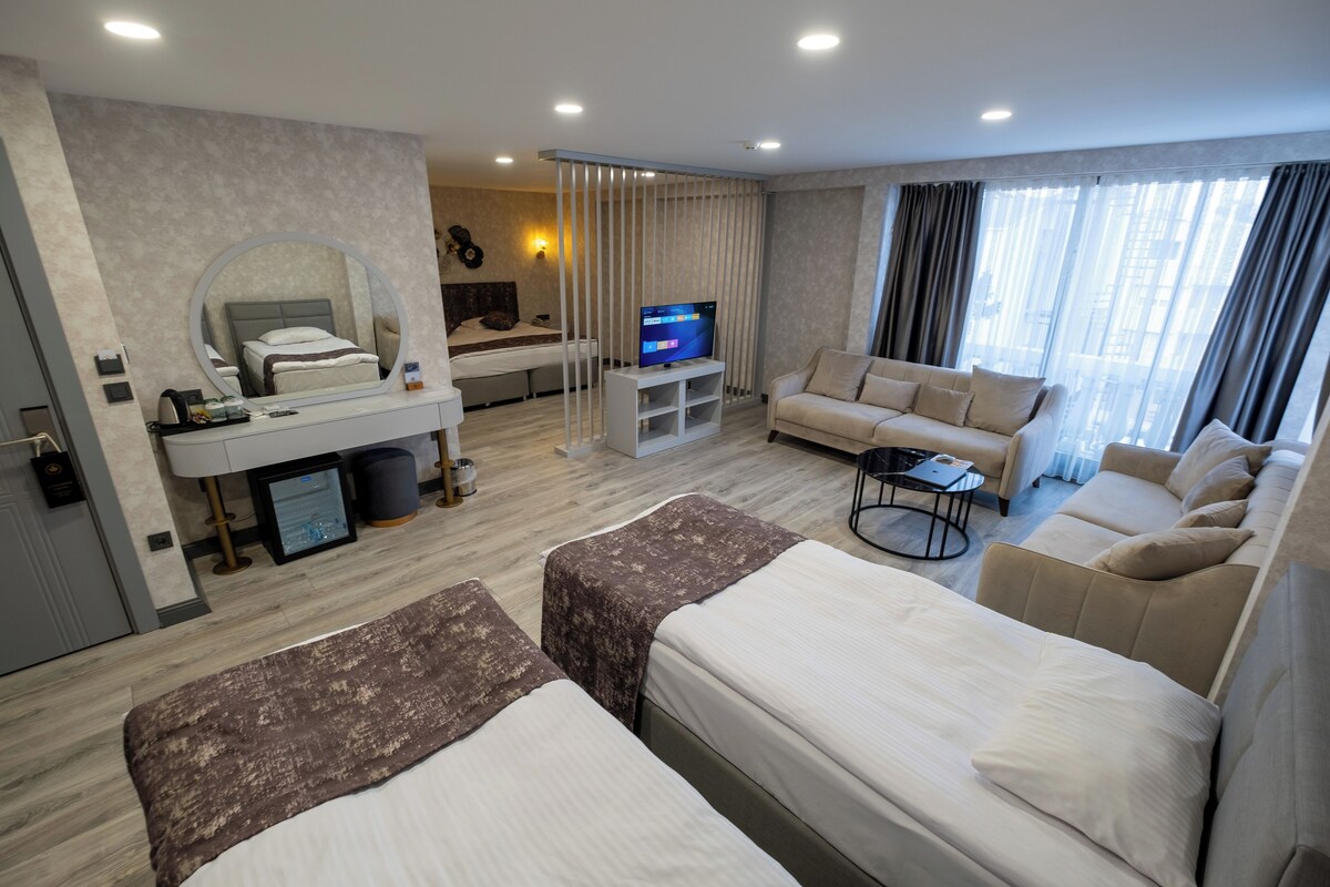 Deluxe Quadruple Room, City View | Premium bedding, minibar, in-room safe, blackout drapes