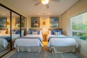 A hotel room with two beds, a ceiling fan, a large window with a view of greenery, and artwork on the walls. - Montecielo 4E 3 bdrs ocean view in Los Suenos (Herradura)