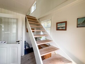 A staircase with wooden steps and white walls, leading to a door. - 6 Person Holiday Home in Bedsted Thy (Bedsted)