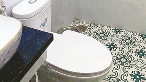 A bathroom with a shower, toilet, and sink.