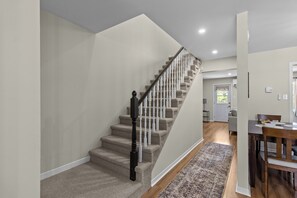 The staircase leads to the home's three comfortable bedrooms and full bathroom. - Welcome to The Crossing, a thoughtfully restored 3-bedroom home on a quiet residential street in historic St. John's. Enjoy free off-street parking, a private fenced yard, and all the comforts of home—just minutes from the best of St. John's. (St. John's)