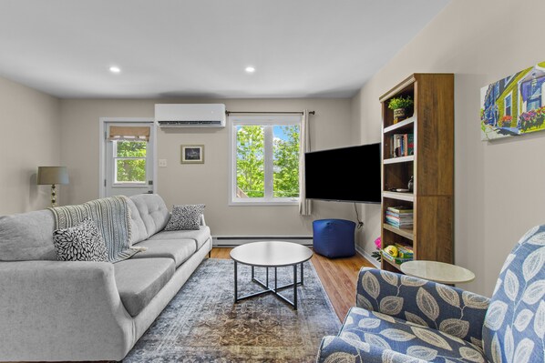 The heart of The Crossing—a bright, comfortable space with Smart TV, cable, and mini-split comfort. - Welcome to The Crossing, a thoughtfully restored 3-bedroom home on a quiet residential street in historic St. John's. Enjoy free off-street parking, a private fenced yard, and all the comforts of home—just minutes from the best of St. John's. (St. John's)