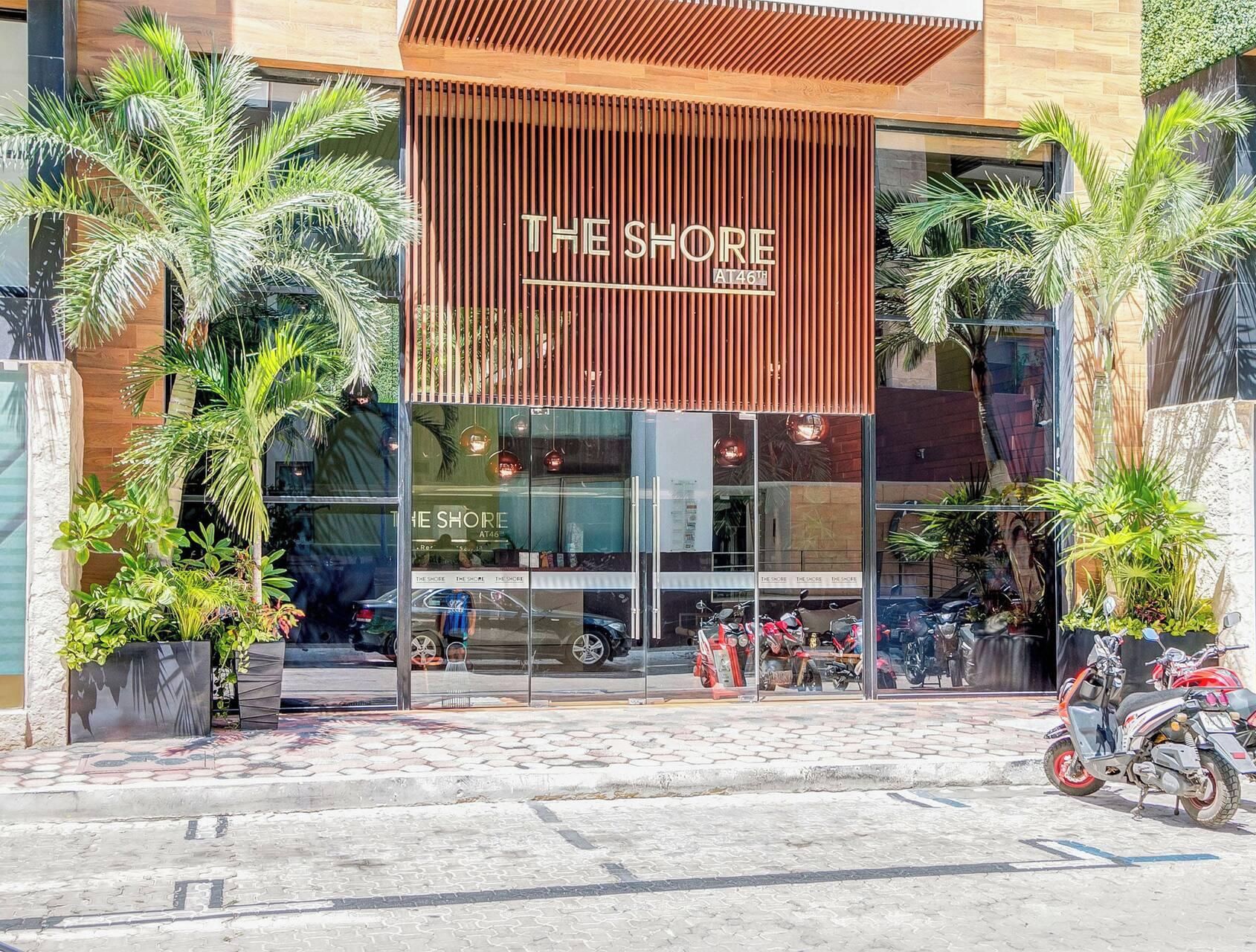 A modern building with a sign reading 'THE SHORE AT46'.