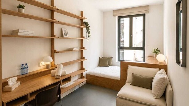 A compact room with a bed, a desk, a chair, a sofa, and built-in shelves. - Maison Bruxelles (Schaerbeek)