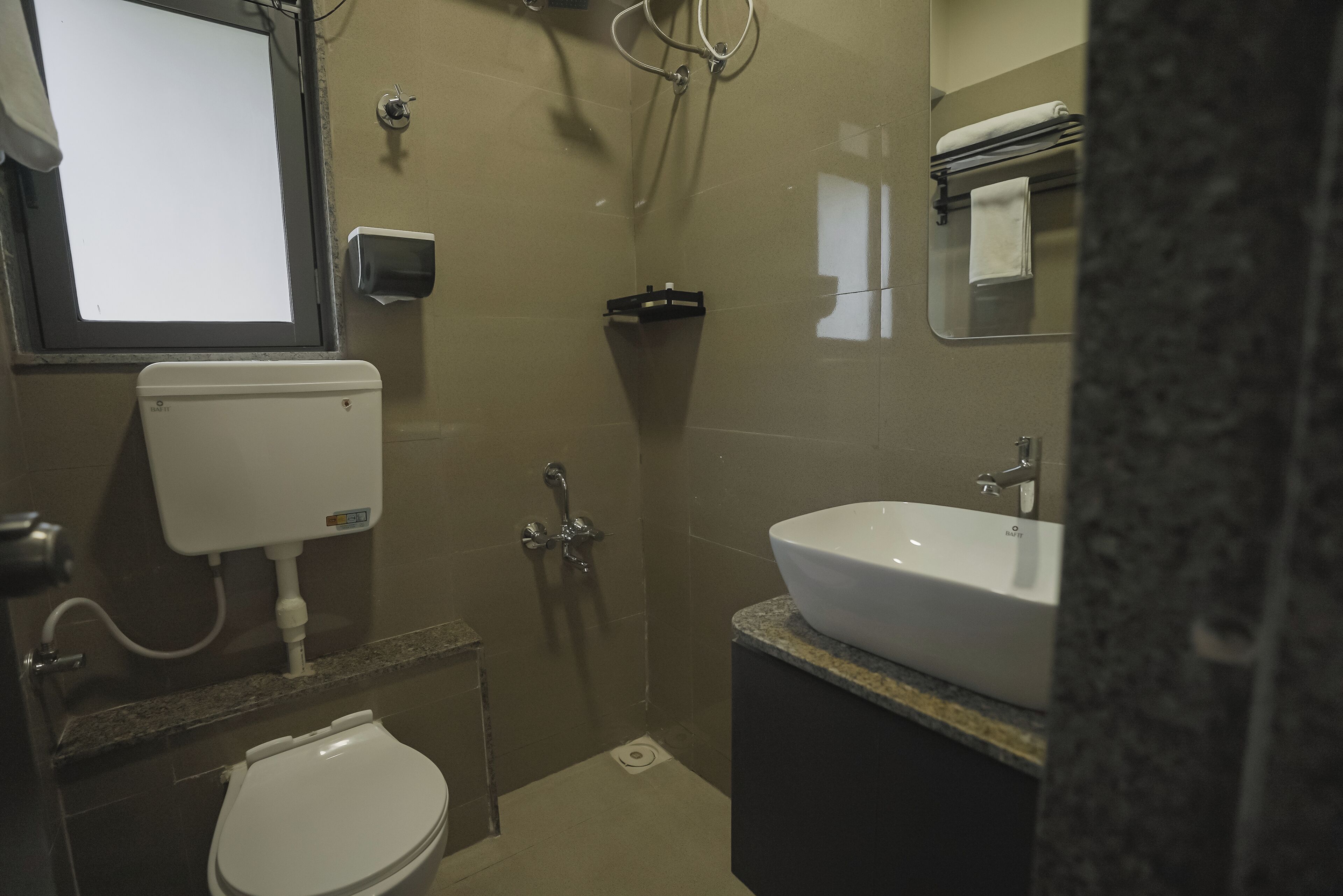 A compact bathroom with a toilet, bidet, and sink.
