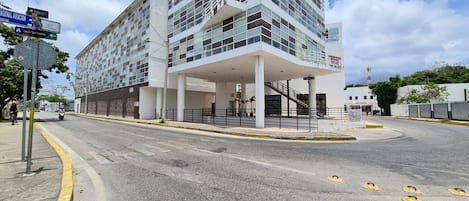 A modern building with a covered entrance and a staircase leading to the upper floors.