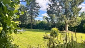 A grassy outdoor area with trees and a bench. - Grand French Family Holiday Home (Saint-Germain-sur-Bresle)
