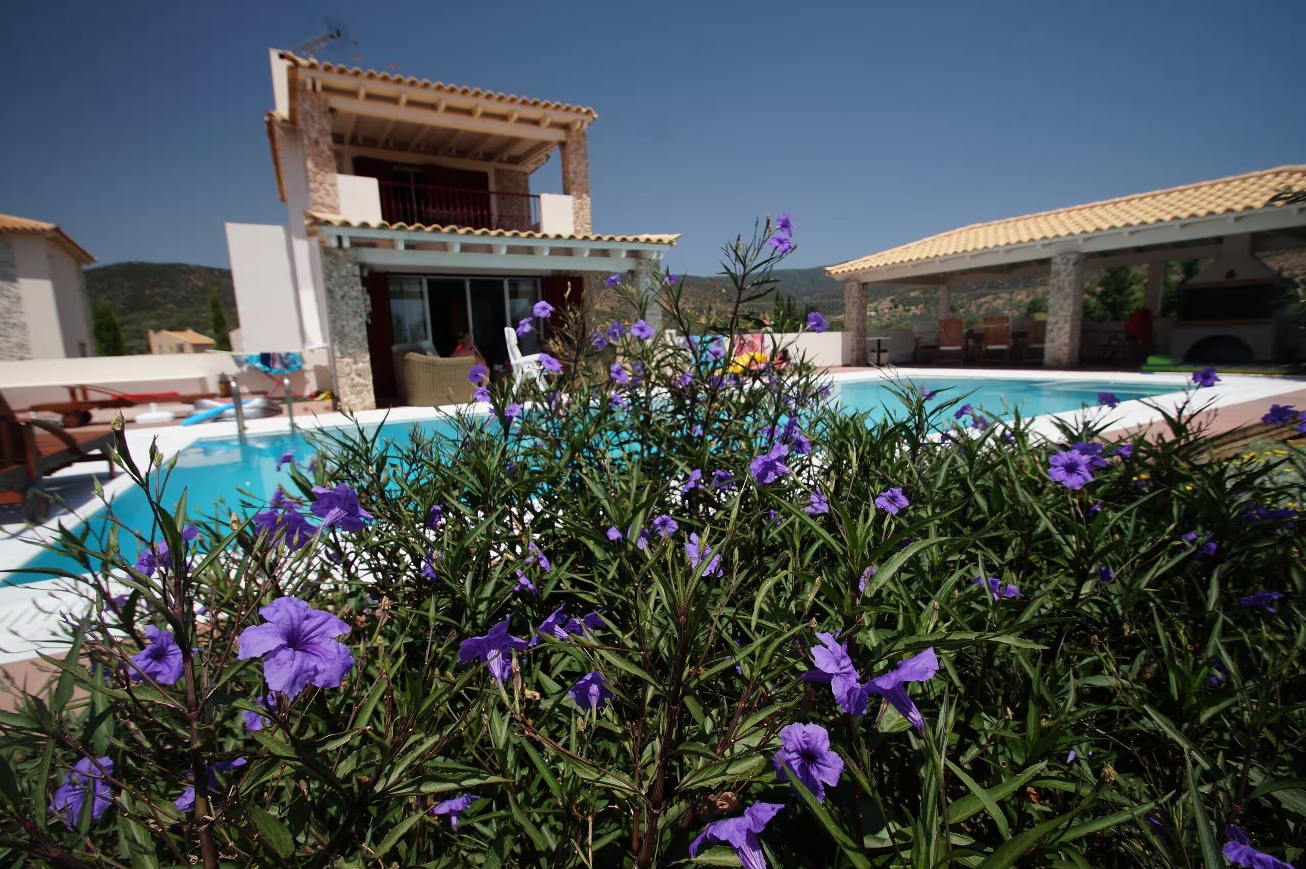 A pool area with a building in the background.