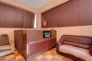 A reception area with a reception desk labeled 'HOTELO' and a couch.