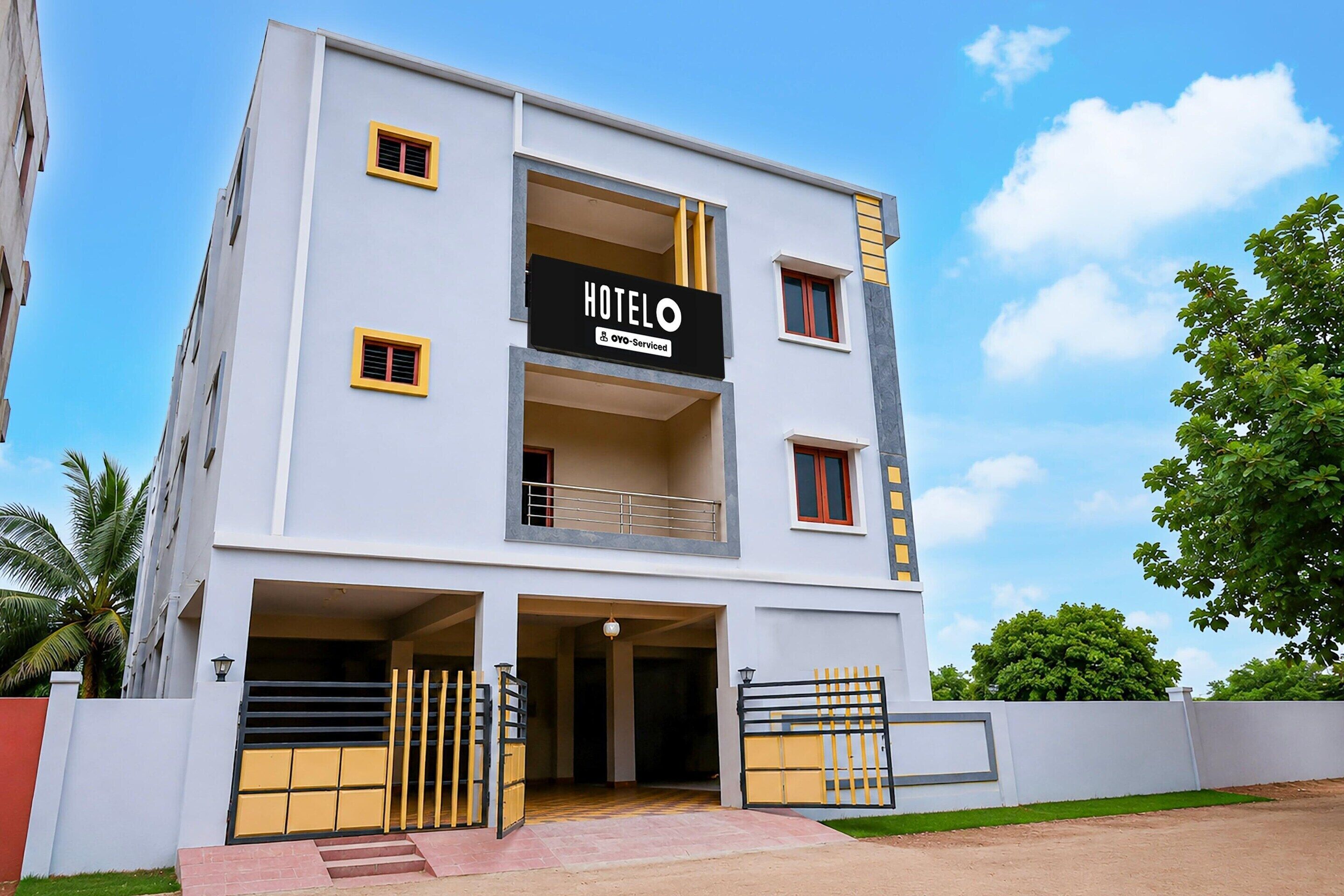 A two-story hotel with a sign indicating it is serviced by OYO.