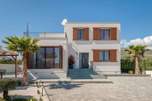 A modern two-story house with a balcony, large windows, and a front door. - Modern Escape Villa with Private Pool (Solin)