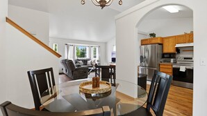 A modern interior with a dining area, kitchen, and living space.