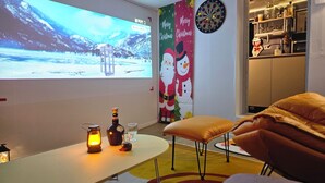 A cozy room with a flat-screen TV, a dartboard, and a Christmas-themed wall decoration. - [Binsheim HBC-301] Relaxation in Central Seoul on the Best Night View Rooftop (Seoul)