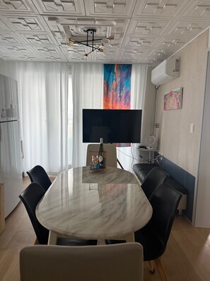 A modern living room with a marble dining table, black leather chairs, a flat-screen TV, and a colorful abstract painting on the wall. - [Binsheim HBC-301] Relaxation in Central Seoul on the Best Night View Rooftop (Seoul)