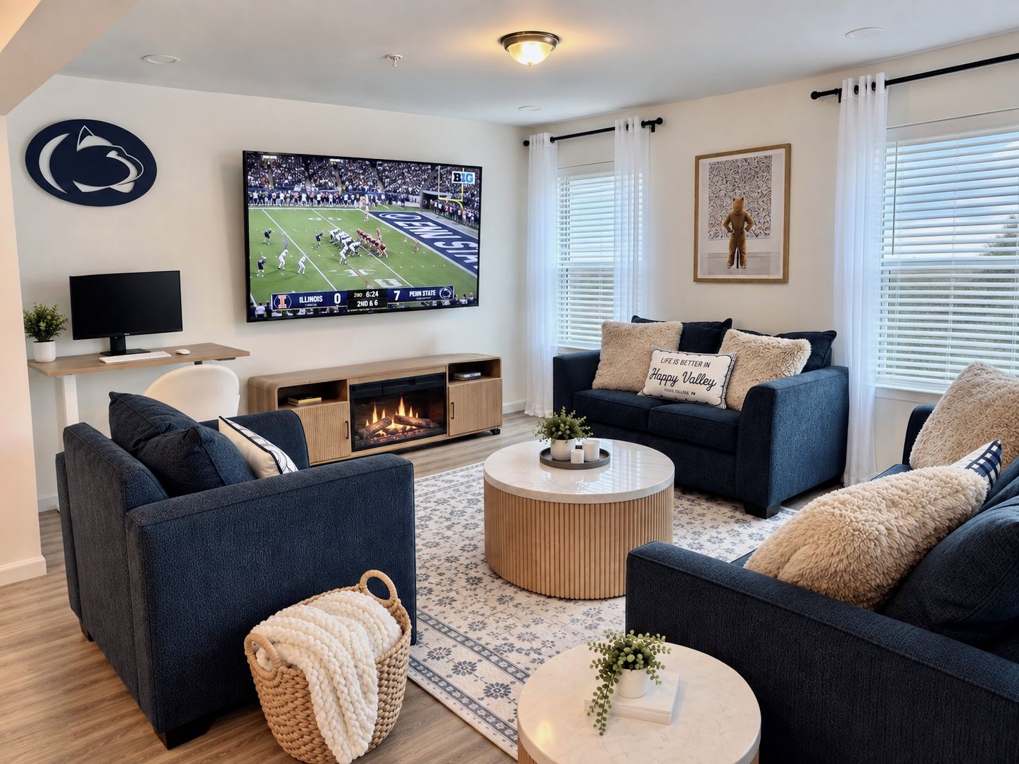 A modern living room with a flat-screen TV, sofas, a fireplace, and a large window with blinds.