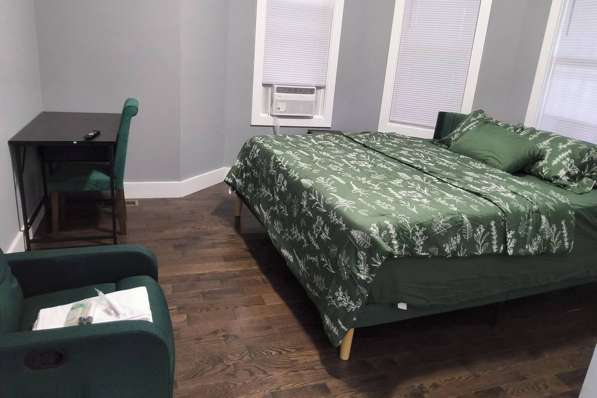 Una habitación con una cama, un escritorio y una silla.