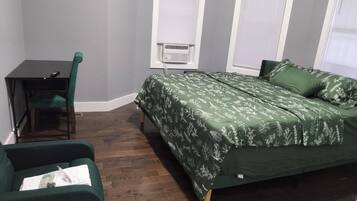 A room with a bed, a desk, and a chair.