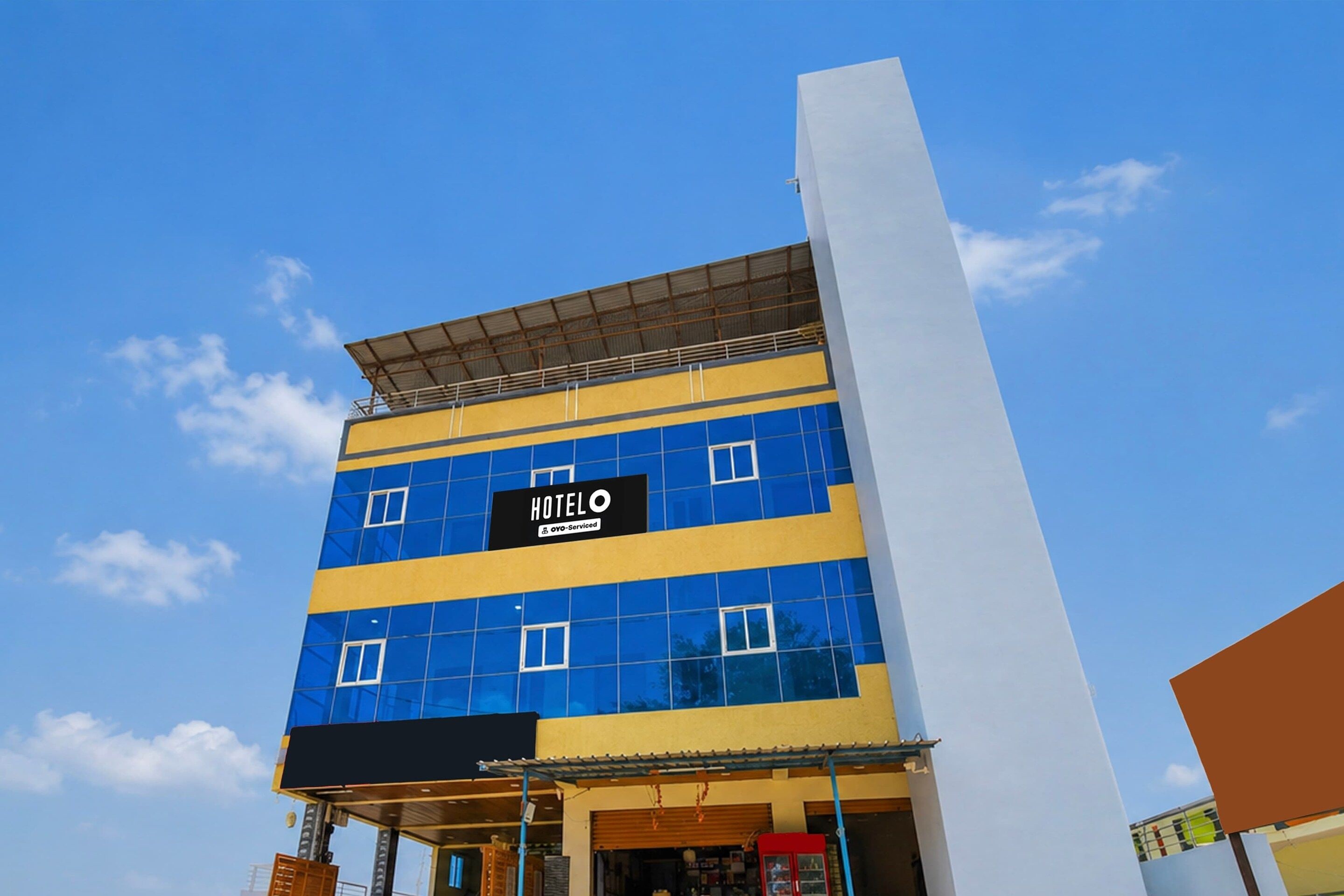 A hotel building with a sign reading 'HOTEL' and a logo indicating it is serviced by OYO.