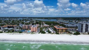 A coastal hotel with multiple buildings, a beach, and a marina. - Shalimar 302 (Indian Rocks Beach)