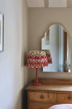 A wooden dresser with a mirror above it and a patterned lamp on top. - Cosy 3-bed cottage in sought after village Freshford. Stunning views of valley. (Freshford)