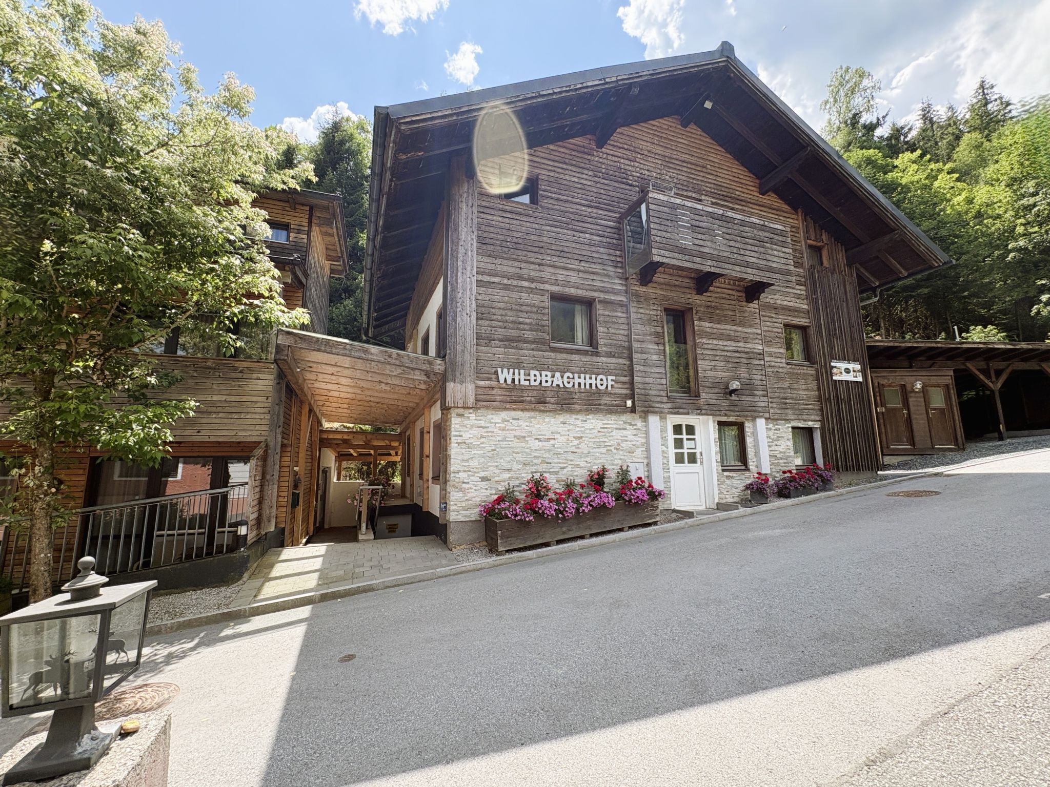 A wooden building with a sign reading 'WIEDBACHHOF.'