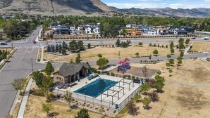 A residential area with a swimming pool, houses, and a playground. - Modern luxury home - great for families (Golden)