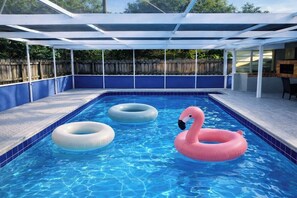 A swimming pool with a covered area, surrounded by a wooden fence. - Family Pool Oasis Near Hard Rock • Beaches • Airport (Hollywood)
