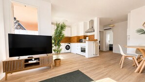 A modern apartment with a living room, kitchen, dining area, and a hallway leading to a bedroom. - Apartment with a terrace in Cannes (Cannes)